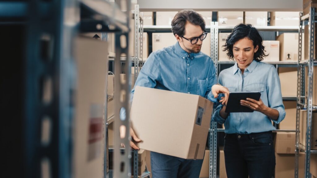 Business owners organizing inventory in storage