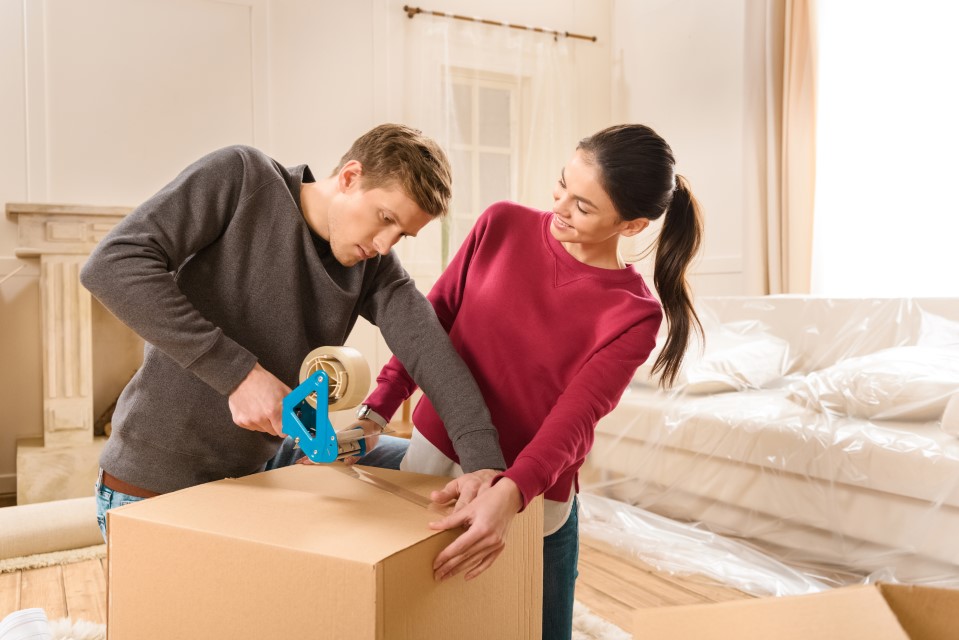 Friends helping each other pack for a move