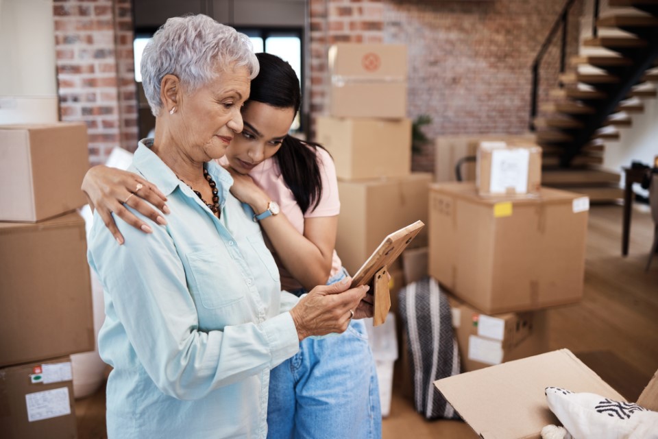 Mother and daughter packing personal items for self-storage